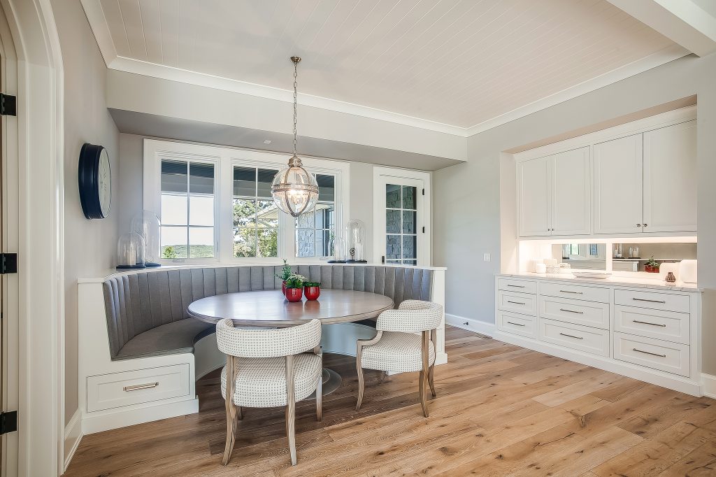 A rounded banquette, and a custom-matched table made by Miller Cabinetry, a company who makes specialty cabinetry in Fort Wayne Indiana